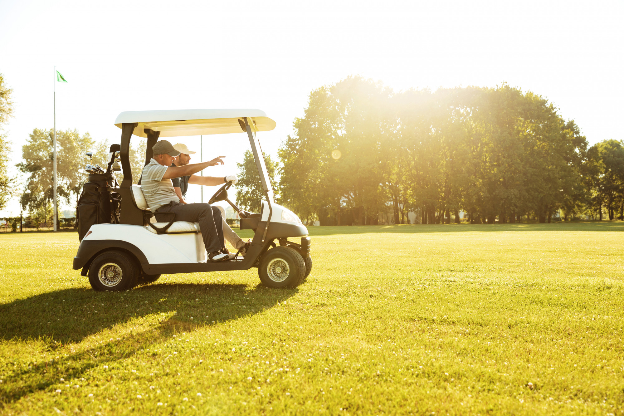 golfers driving in a golf cart